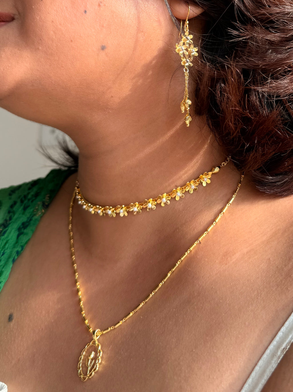 Full Motiya Capsule Collection worn together — Motiya Choker, Lily Necklace layered beneath, and Motiya Danglers — styled with a white ruched top and green printed dupatta, photographed in warm natural light.