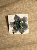 Pallavi earrings on a Ormi branded card with a textured beige background