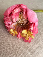 Detail view of Manjari floral ring resting on the delicate petals of a fresh pink lotus flower.