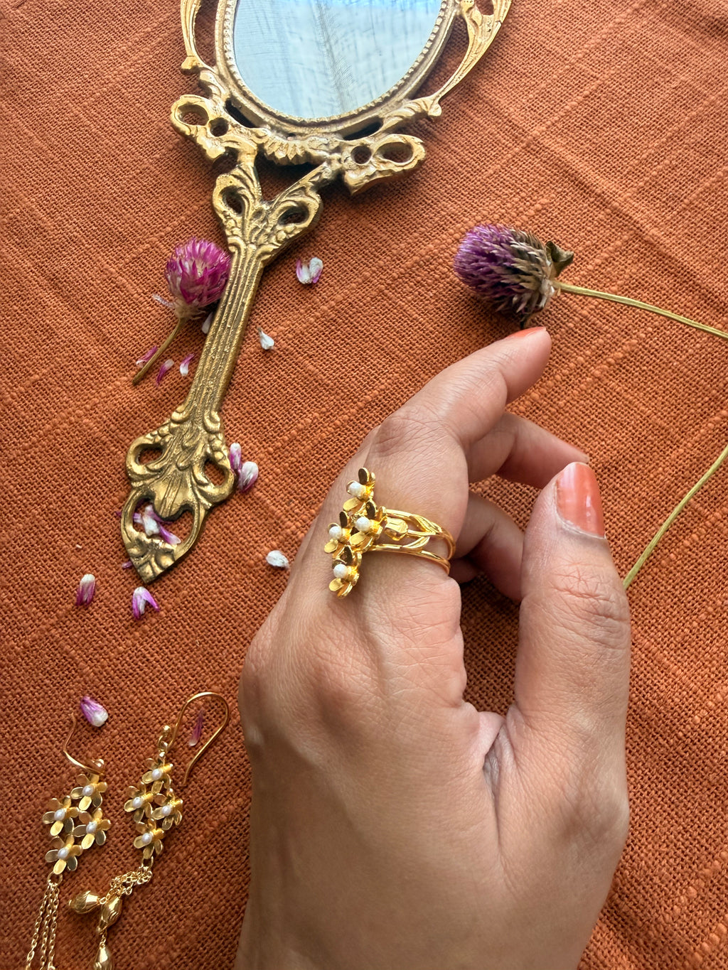 Side angle of Motiya Lily Ring worn on a gently curled hand, showing the jasmine flower cluster and lily detailing