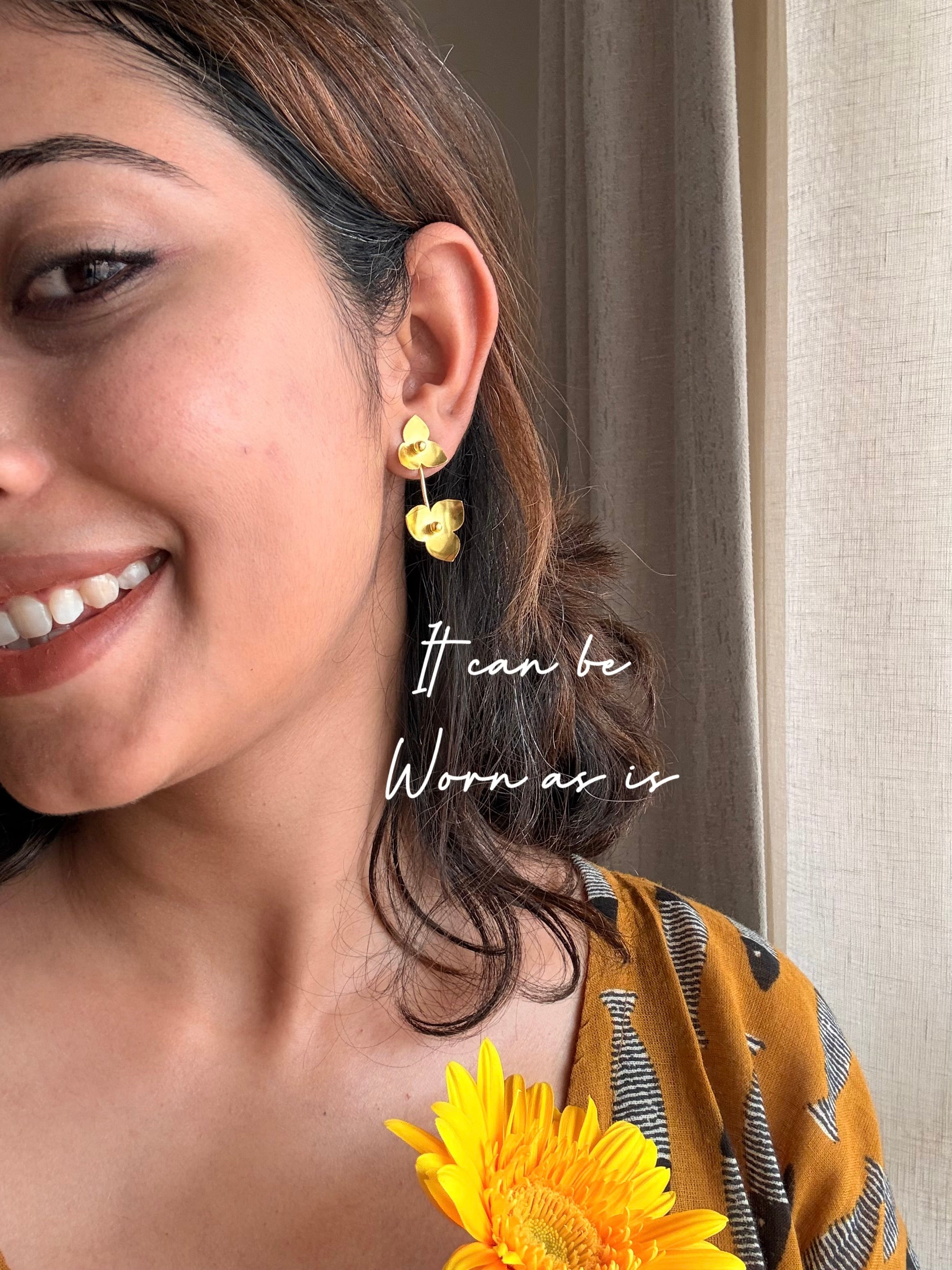 Woman wearing juhi floral earrings with a neutral background, with text- it can be worn as is